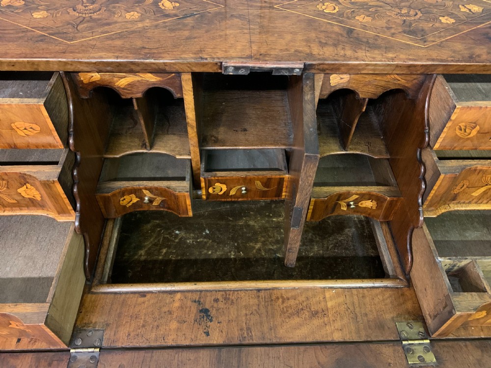 An 18th-century Dutch walnut bureau featuring detailed floral marquetry inlay across the slant-front lid and drawer fronts, accented with brass handles. View XIII