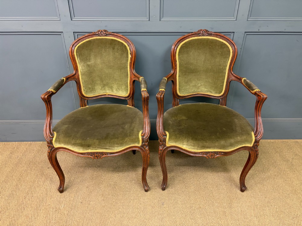 A pair of French carved mahogany fauteuil armchairs featuring cabriole legs and olive green velvet upholstery. View II