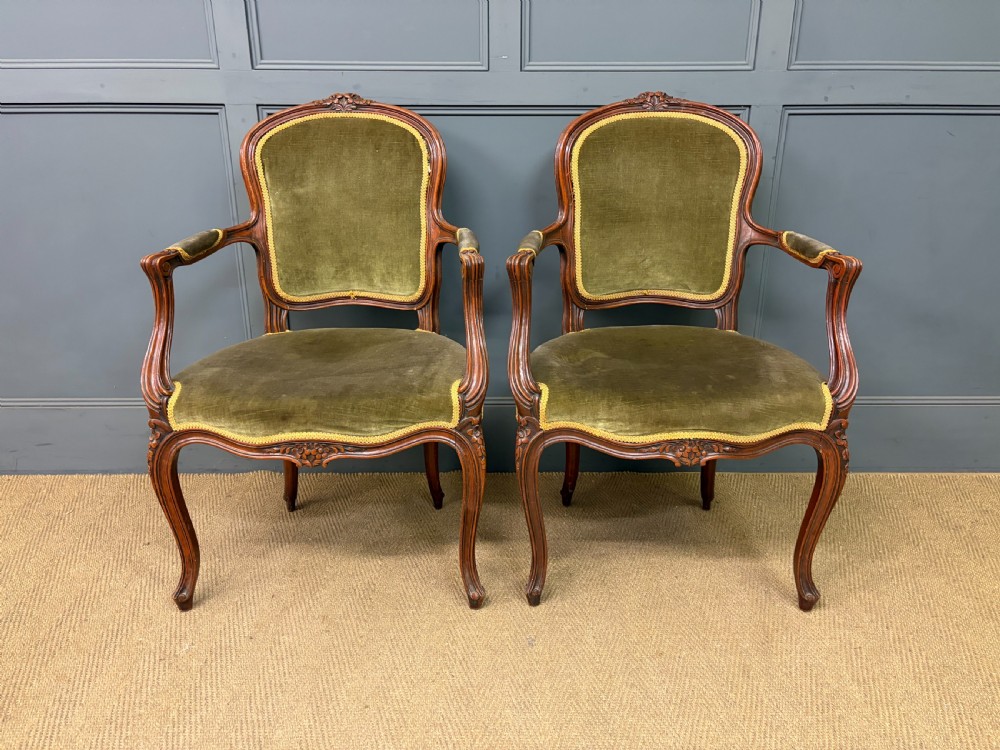 A pair of French carved mahogany fauteuil armchairs featuring cabriole legs and olive green velvet upholstery. View III