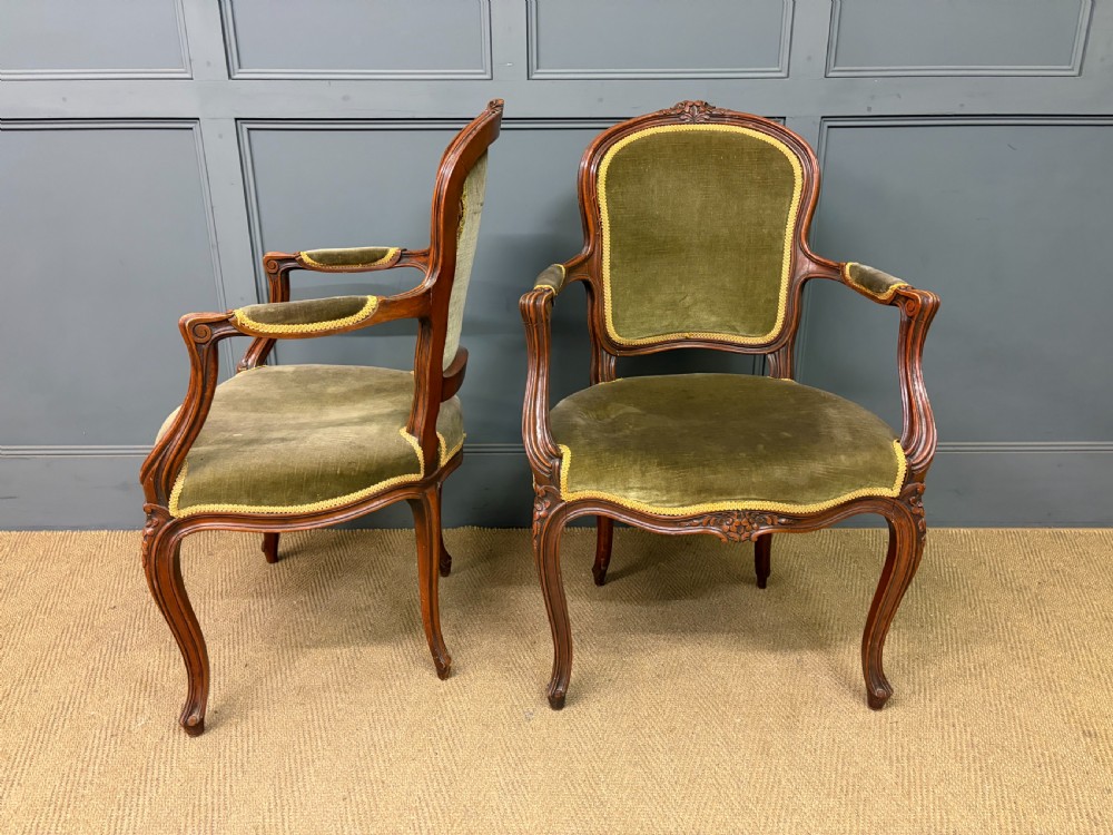 A pair of French carved mahogany fauteuil armchairs featuring cabriole legs and olive green velvet upholstery. View IV