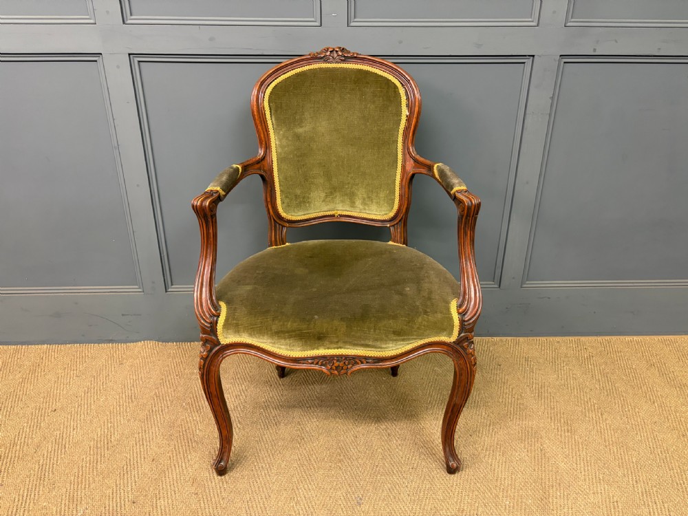 A pair of French carved mahogany fauteuil armchairs featuring cabriole legs and olive green velvet upholstery. View VI