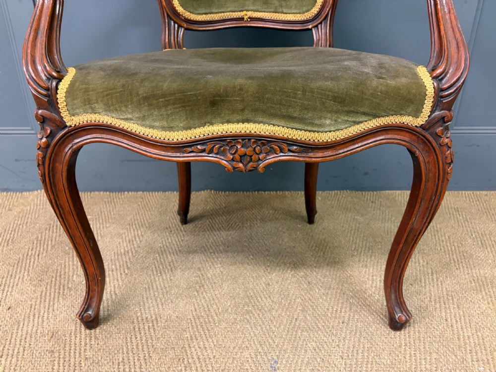A pair of French carved mahogany fauteuil armchairs featuring cabriole legs and olive green velvet upholstery. View VII