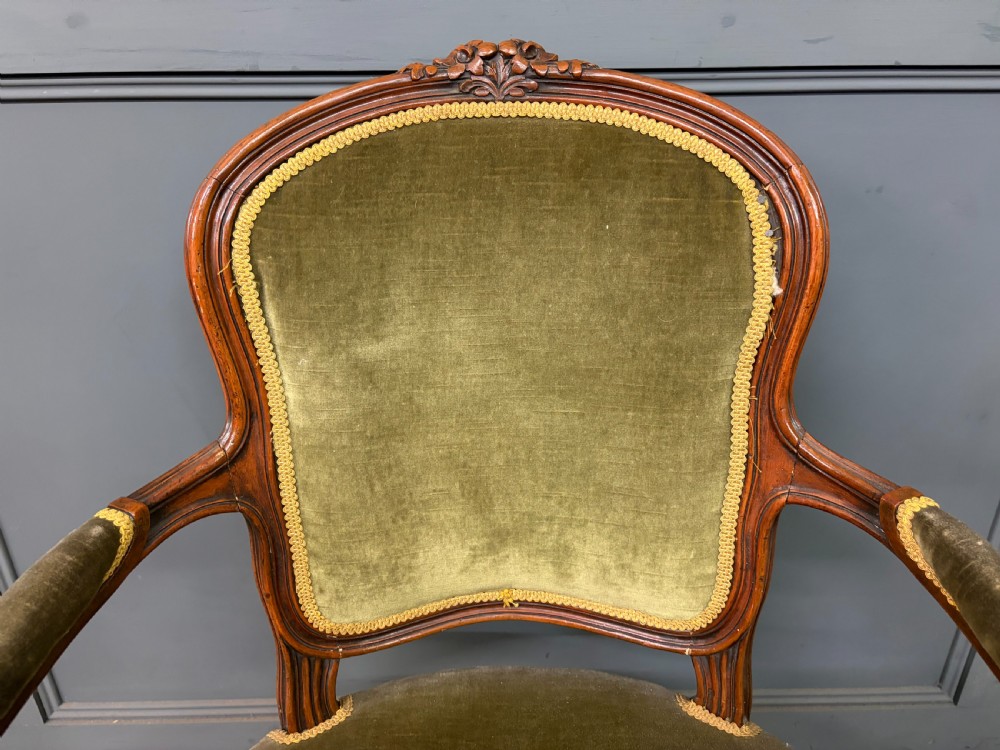 A pair of French carved mahogany fauteuil armchairs featuring cabriole legs and olive green velvet upholstery. View VIII