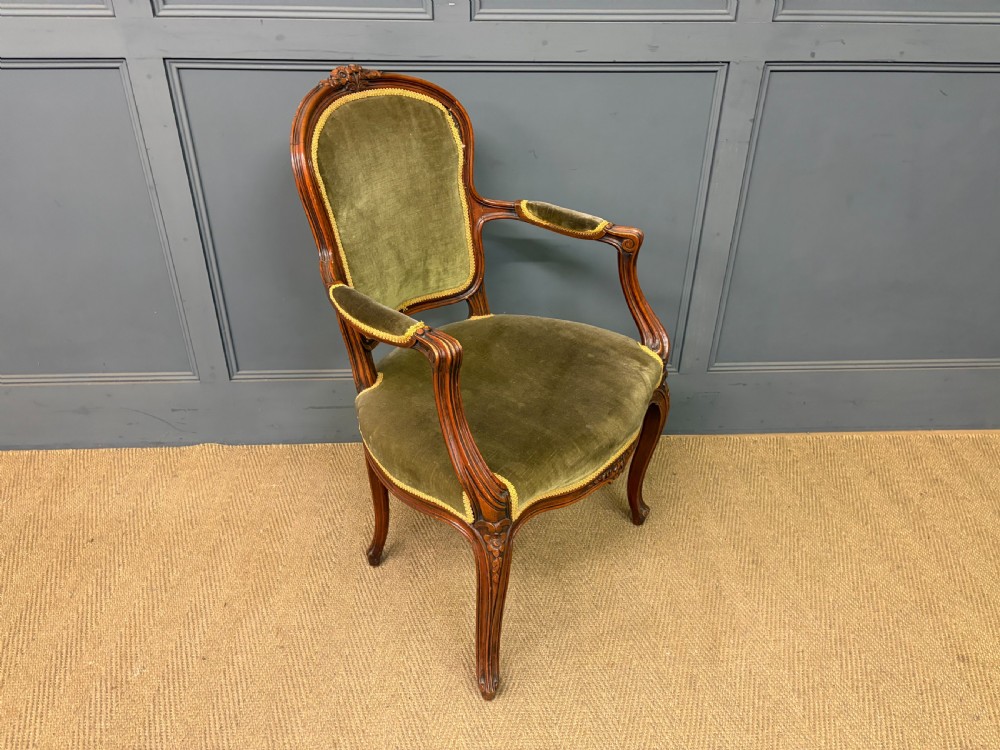 A pair of French carved mahogany fauteuil armchairs featuring cabriole legs and olive green velvet upholstery. View XI