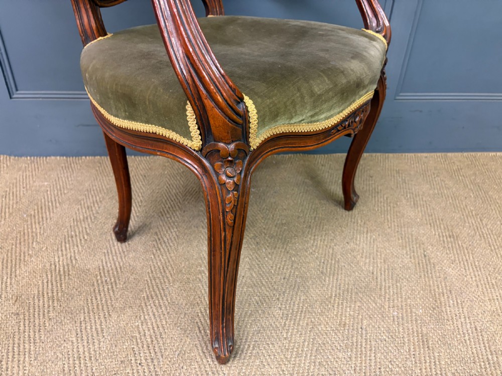 A pair of French carved mahogany fauteuil armchairs featuring cabriole legs and olive green velvet upholstery. View XII