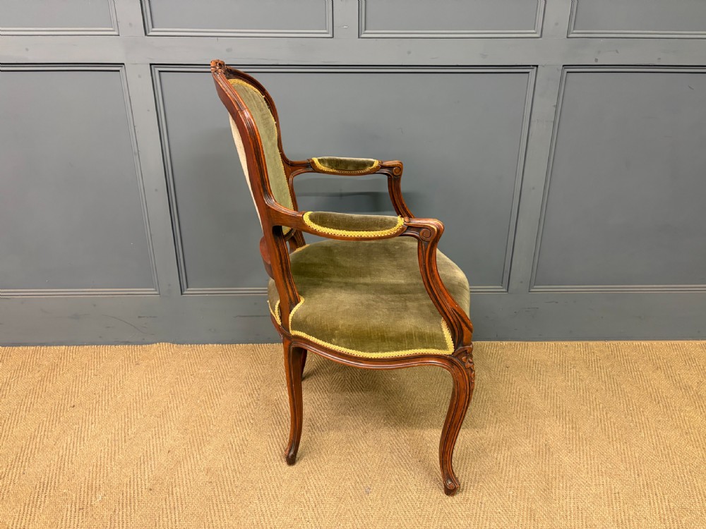 A pair of French carved mahogany fauteuil armchairs featuring cabriole legs and olive green velvet upholstery. View XIII
