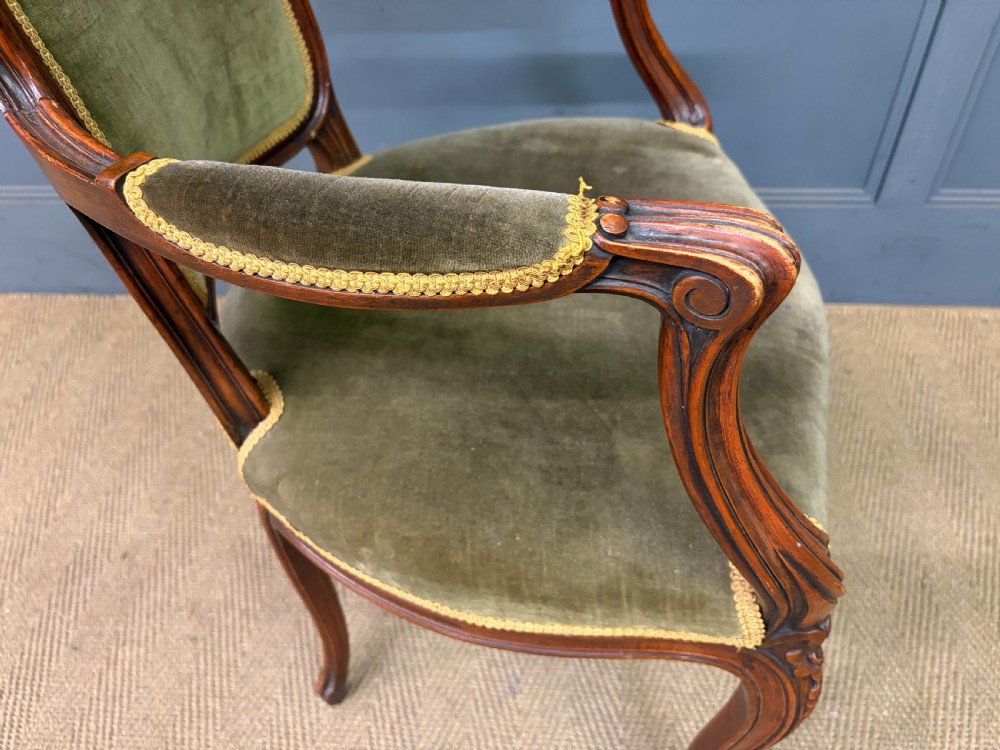 A pair of French carved mahogany fauteuil armchairs featuring cabriole legs and olive green velvet upholstery. View XIV