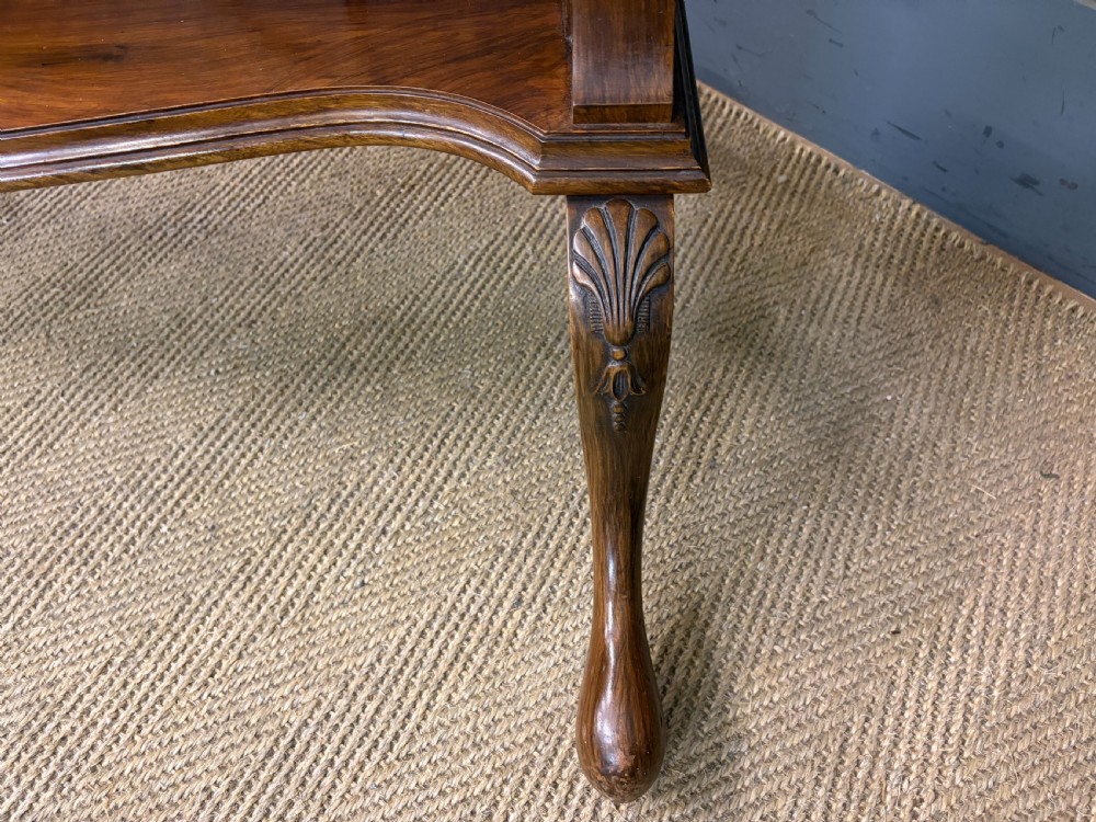 A Queen Anne style walnut cheval mirror with an arched frame, carved shell motif, finial posts, and cabriole legs. View X