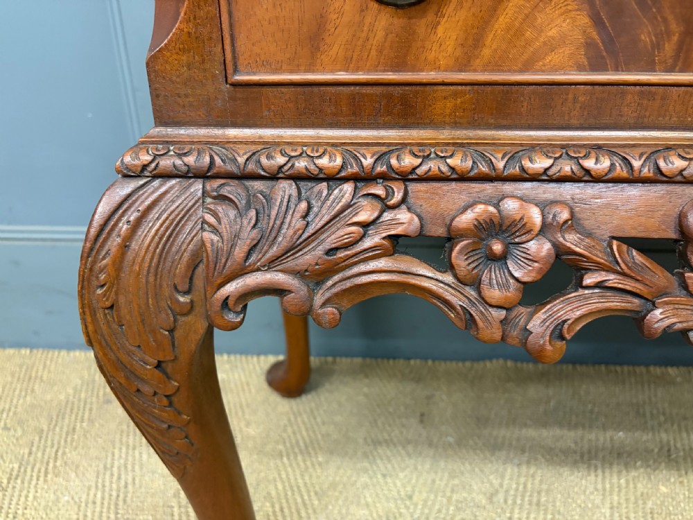 An antique Queen Anne style glazed display cabinet in warm brown wood featuring arched doors with glass panes, drawers with brass handles, and carved cabriole legs. View IX
