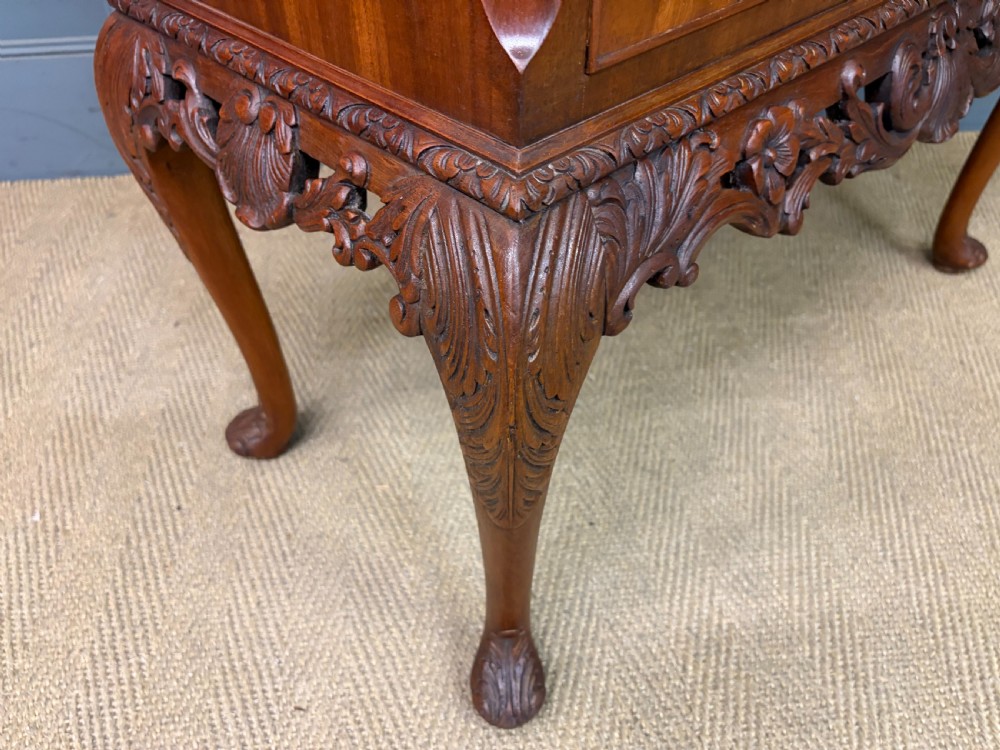 An antique Queen Anne style glazed display cabinet in warm brown wood featuring arched doors with glass panes, drawers with brass handles, and carved cabriole legs. View XVIII