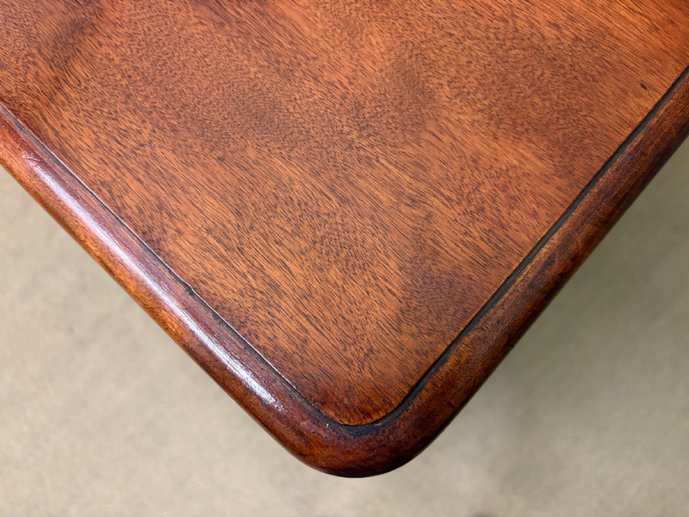 A Victorian chest of drawers in warm brown figured timber featuring turned handles and a plinth base. View XV