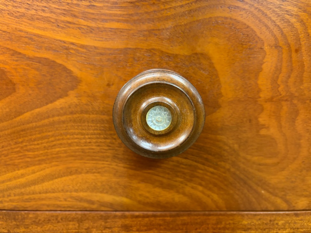 A Victorian flame mahogany chest of drawers featuring two short over three long drawers flanked by spiral turned columns resting on a solid plinth base. View VII