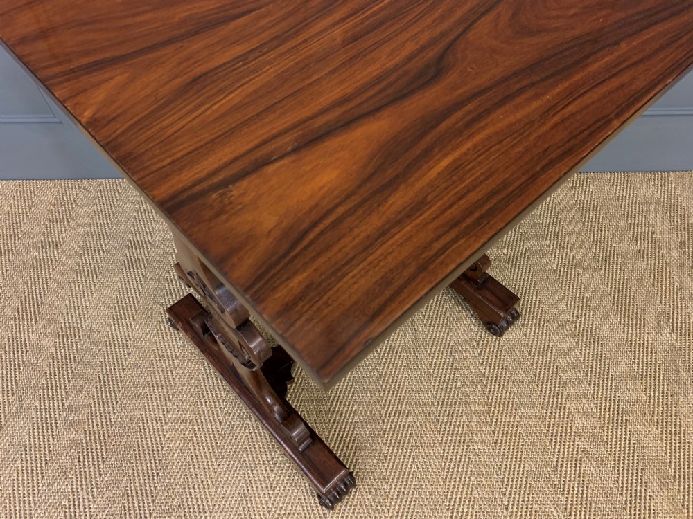 A William IV rosewood work table featuring a square top above a pleated cream fabric basket supported by carved scroll legs. View VIII