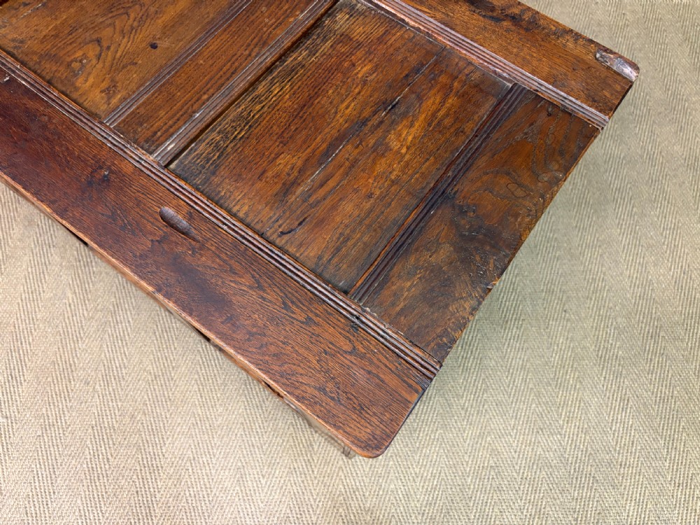 A Georgian oak coffer featuring a three-panel front framing, a hinged top, and a brass keyhole escutcheon. View XVII