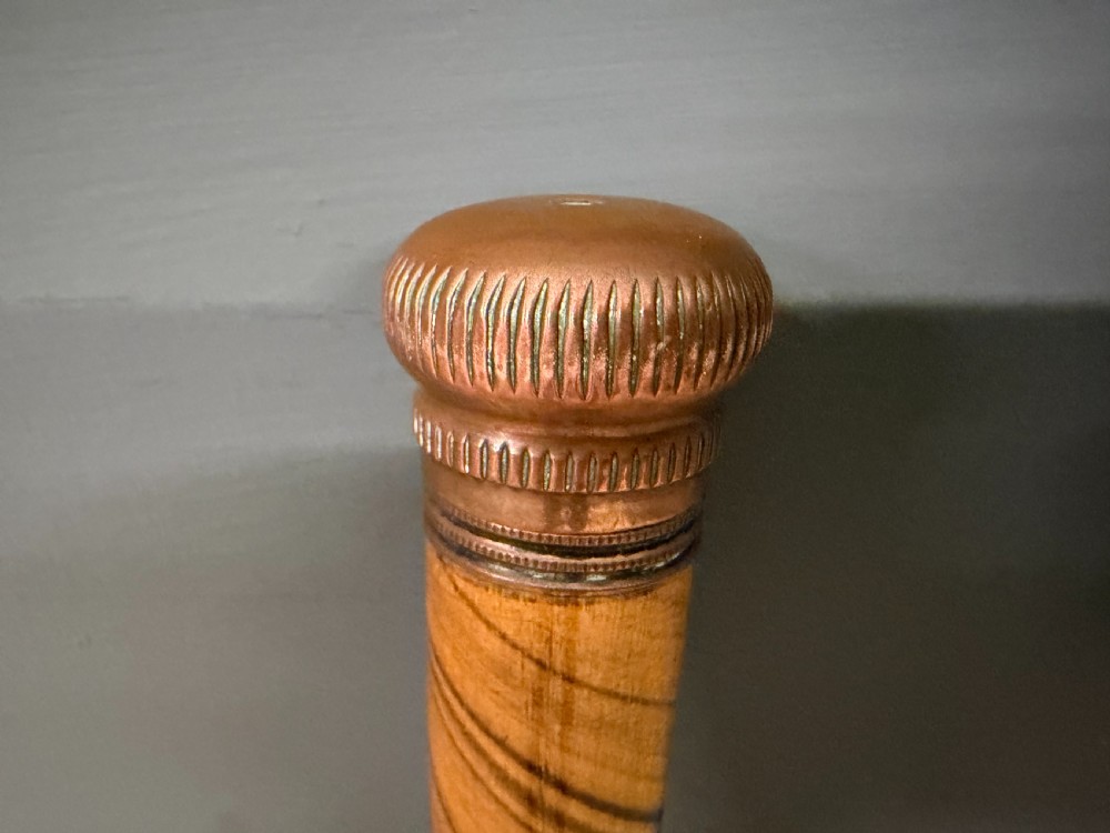 A Victorian wooden walking cane featuring a spiral pattern along the tapered shaft and a metal collar. View IV