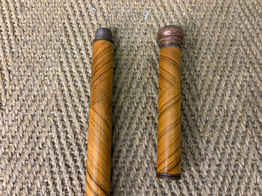 A Victorian wooden walking cane featuring a spiral pattern along the tapered shaft and a metal collar. View V