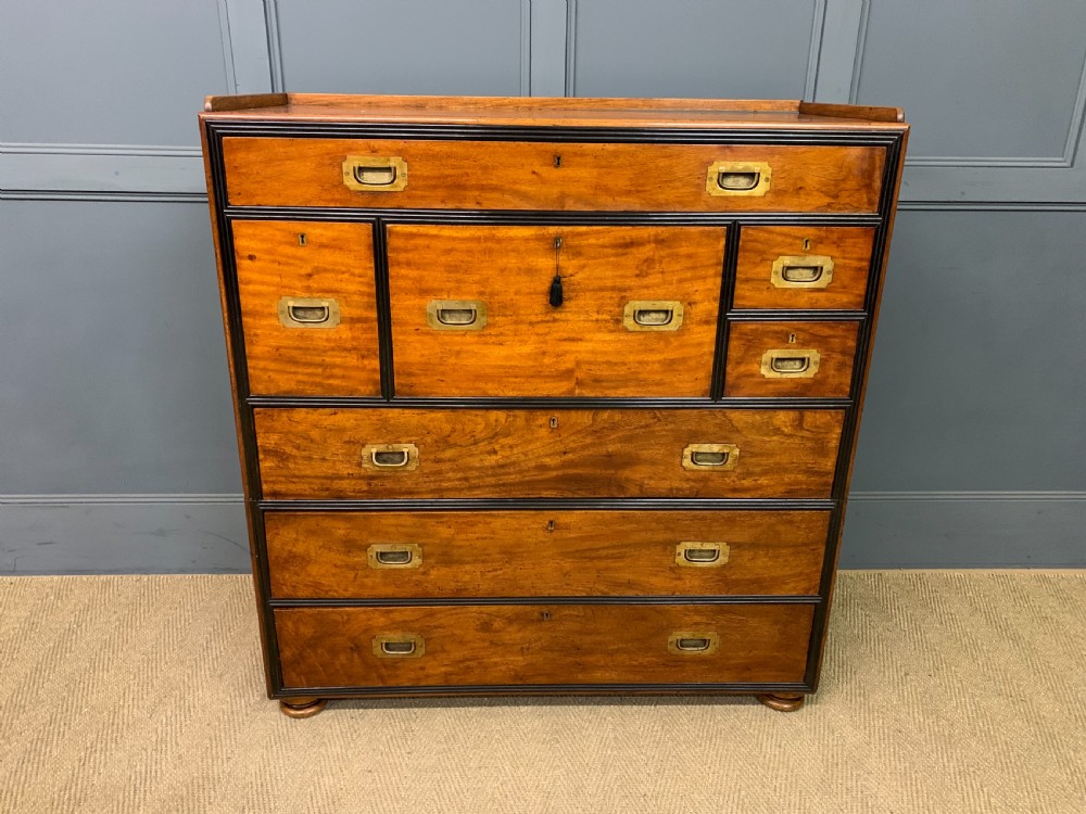 A nineteenth-century camphor wood military campaign chest with dark wood borders, flush brass handles, and a central drop-front secretaire section. View II