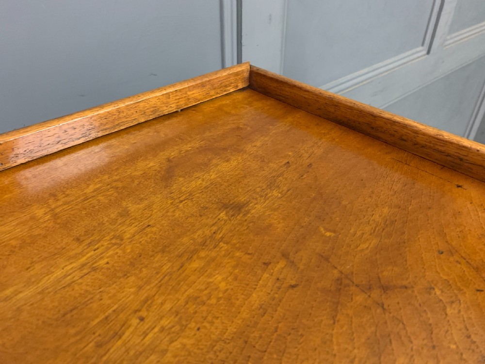 A nineteenth-century camphor wood military campaign chest with dark wood borders, flush brass handles, and a central drop-front secretaire section. View VIII