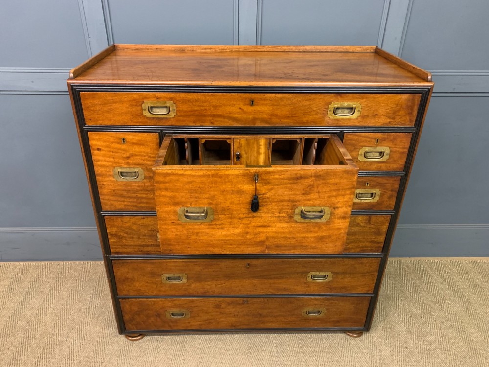 A nineteenth-century camphor wood military campaign chest with dark wood borders, flush brass handles, and a central drop-front secretaire section. View IX
