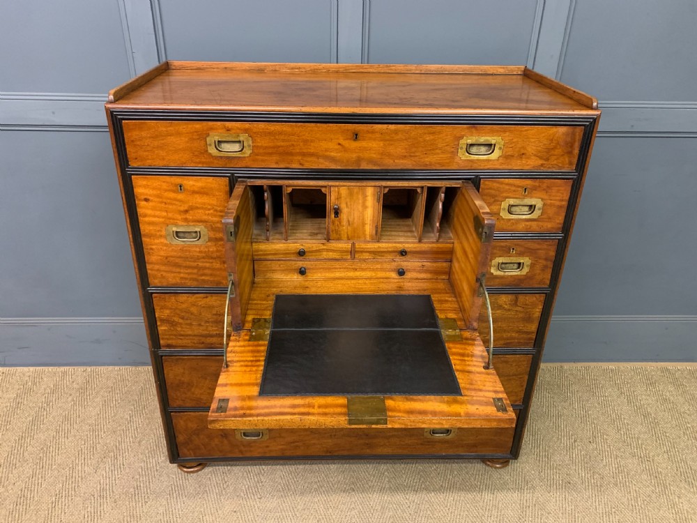 A nineteenth-century camphor wood military campaign chest with dark wood borders, flush brass handles, and a central drop-front secretaire section. View X