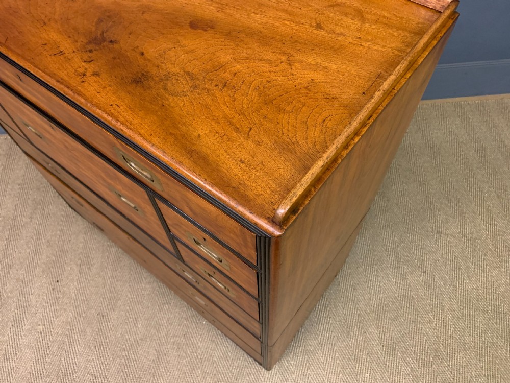 A nineteenth-century camphor wood military campaign chest with dark wood borders, flush brass handles, and a central drop-front secretaire section. View XVIII