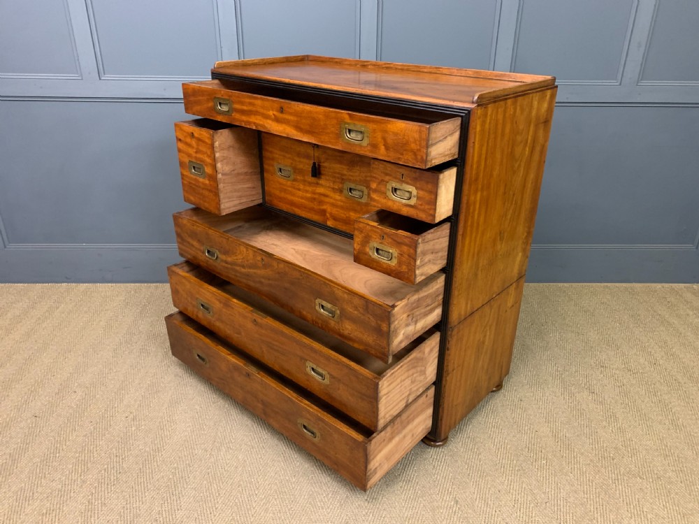 A nineteenth-century camphor wood military campaign chest with dark wood borders, flush brass handles, and a central drop-front secretaire section. View XIX