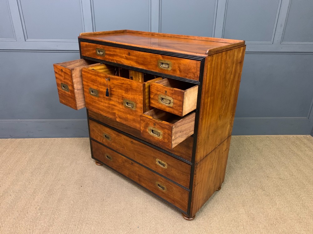 A nineteenth-century camphor wood military campaign chest with dark wood borders, flush brass handles, and a central drop-front secretaire section. View XX