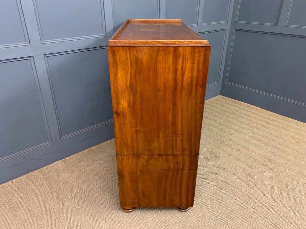 A nineteenth-century camphor wood military campaign chest with dark wood borders, flush brass handles, and a central drop-front secretaire section. View XXV
