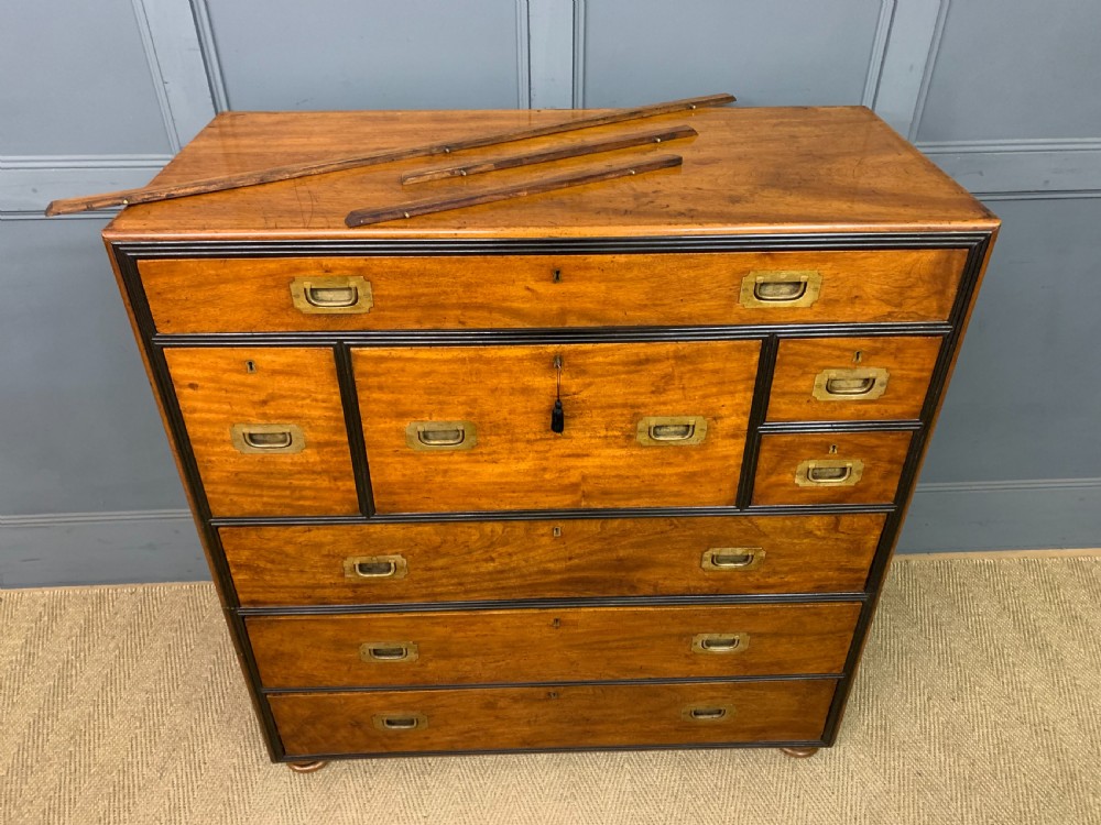 A nineteenth-century camphor wood military campaign chest with dark wood borders, flush brass handles, and a central drop-front secretaire section. View XXVI