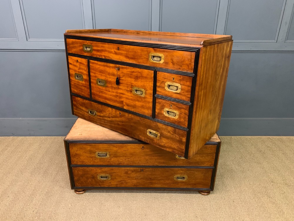 A nineteenth-century camphor wood military campaign chest with dark wood borders, flush brass handles, and a central drop-front secretaire section. View XXVII