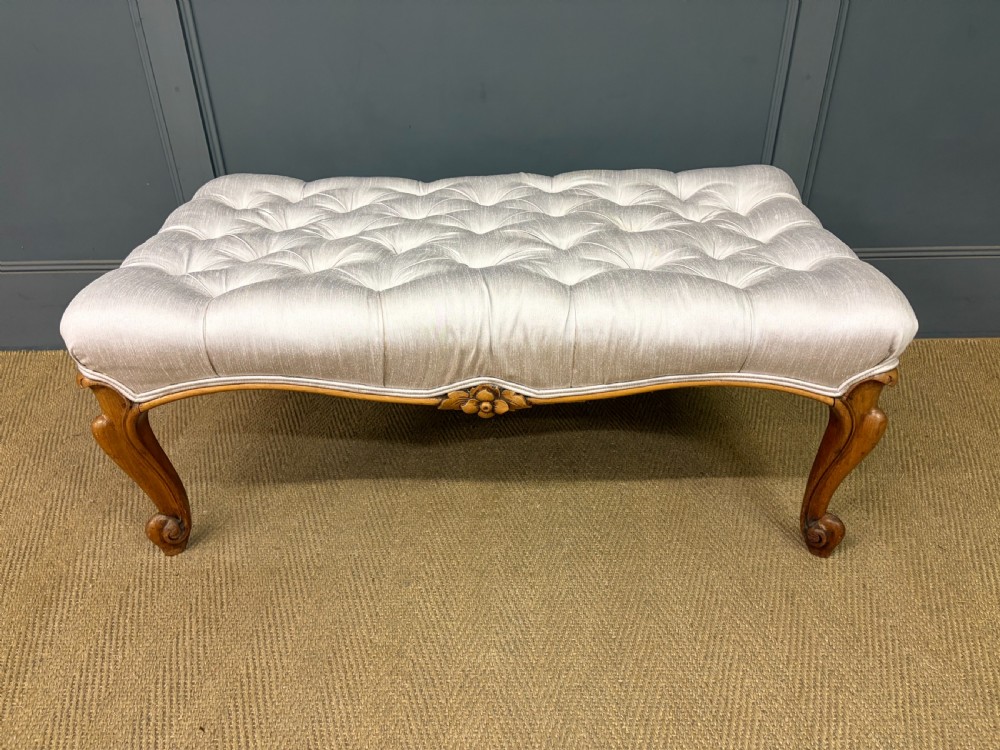 A large rectangular Victorian rosewood stool with deep-buttoned cream upholstery and carved cabriole legs. View V