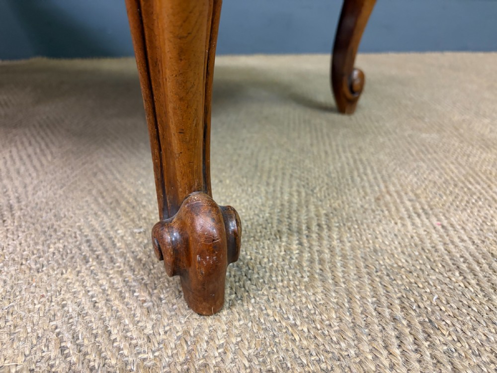 A large rectangular Victorian rosewood stool with deep-buttoned cream upholstery and carved cabriole legs. View XIV