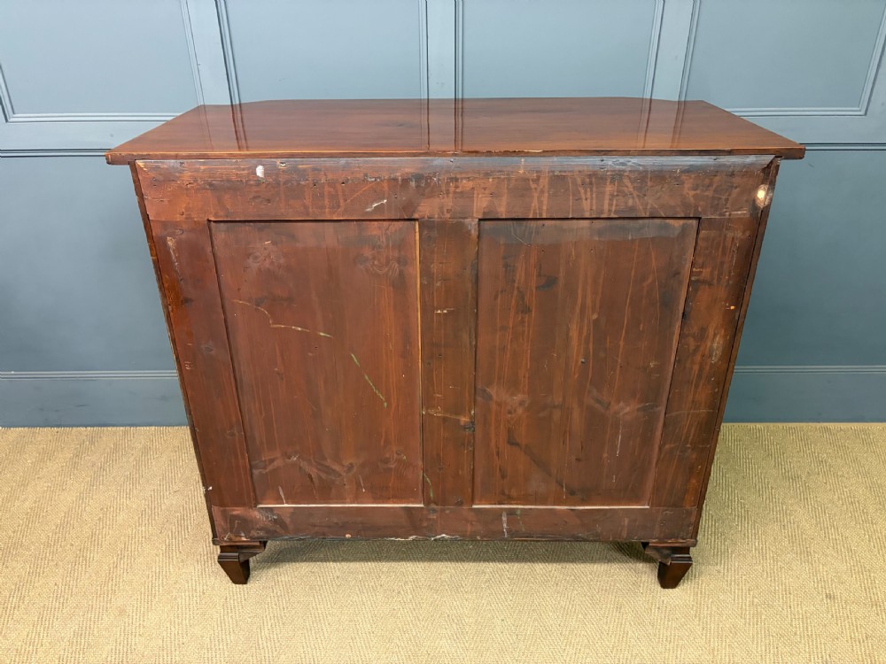 A George IV flame mahogany chest of drawers featuring a bowfront profile, turned wooden handles, and carved side columns. View XVIII