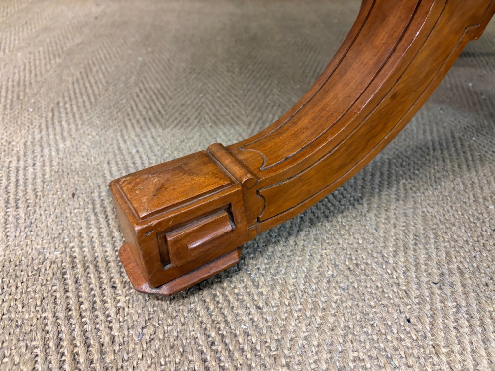 A circular burr walnut centre table featuring a quartered figured veneer top over a turned central pedestal with four carved scroll legs. View XI