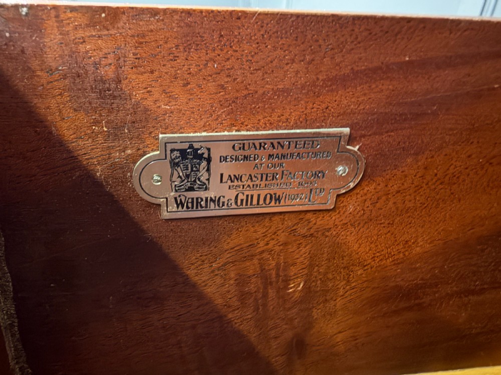 An Art Deco burr walnut chest of four full-width drawers featuring figured veneer panels, decorative brass drop handles, and low bracket feet. View VIII