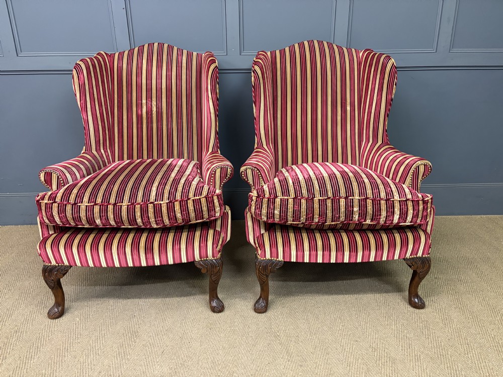 A pair of high-backed wing armchairs upholstered in red and gold striped velvet fabric with carved timber cabriole legs. View IV