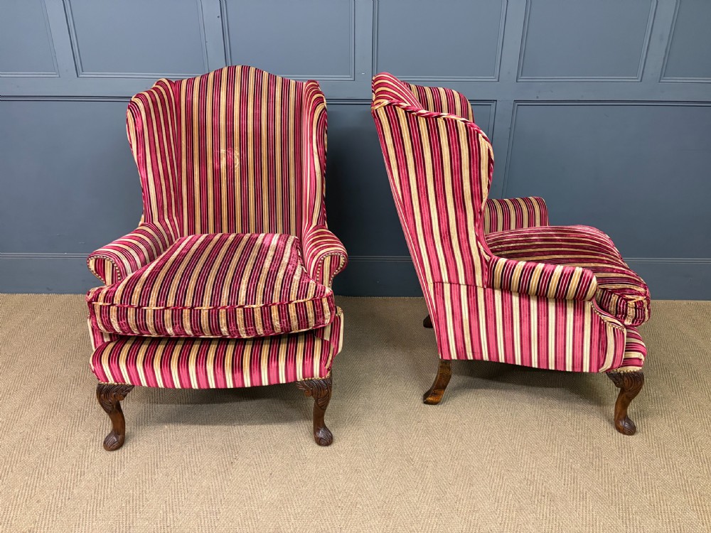 A pair of high-backed wing armchairs upholstered in red and gold striped velvet fabric with carved timber cabriole legs. View VII