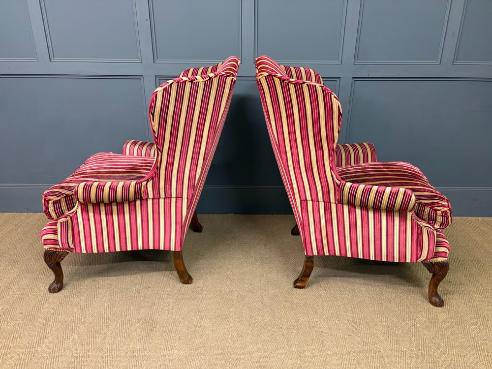 A pair of high-backed wing armchairs upholstered in red and gold striped velvet fabric with carved timber cabriole legs. View VIII