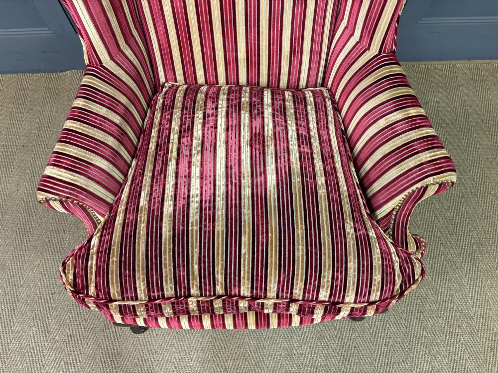 A pair of high-backed wing armchairs upholstered in red and gold striped velvet fabric with carved timber cabriole legs. View XI