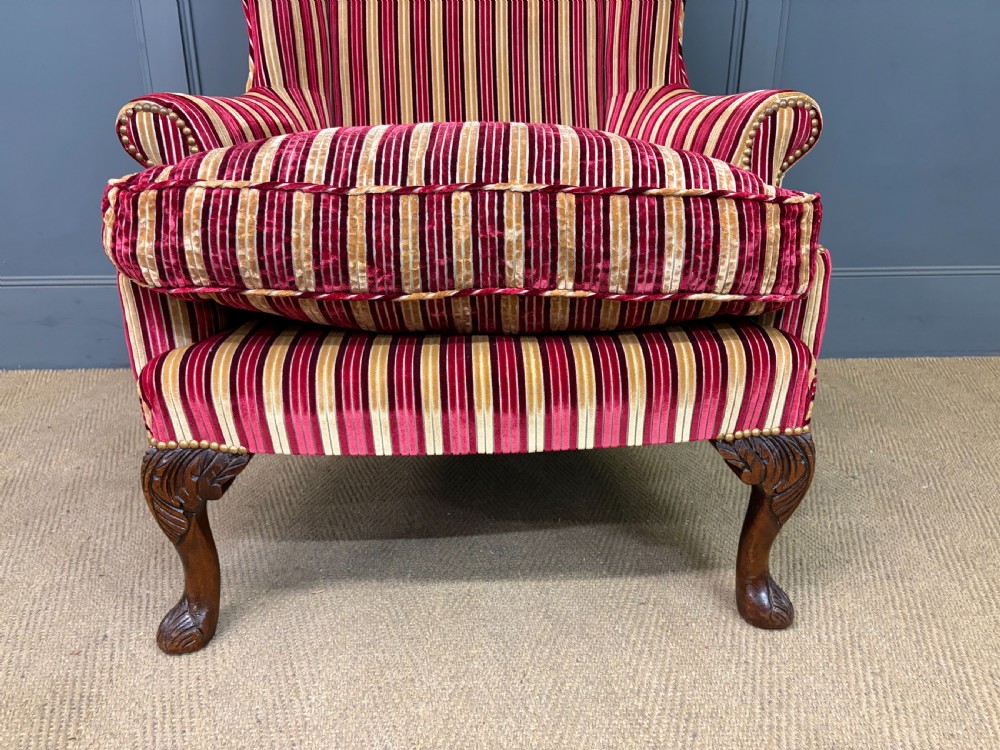 A pair of high-backed wing armchairs upholstered in red and gold striped velvet fabric with carved timber cabriole legs. View XIII