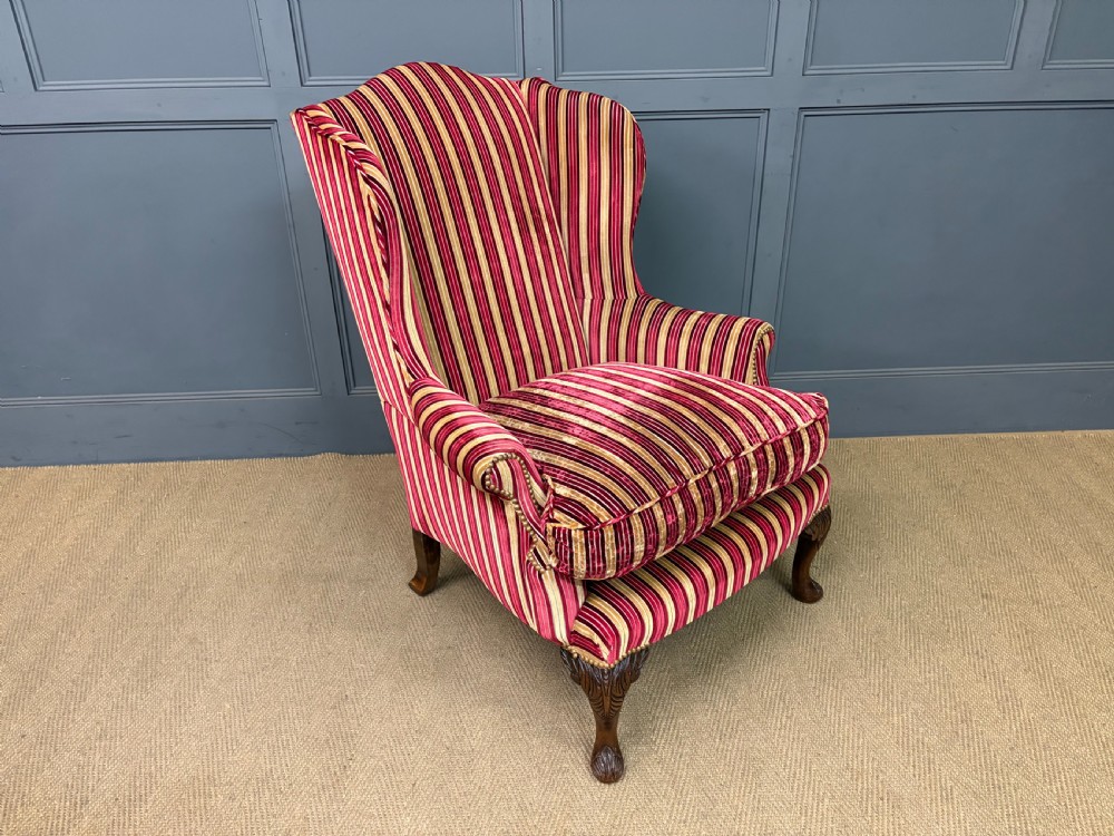 A pair of high-backed wing armchairs upholstered in red and gold striped velvet fabric with carved timber cabriole legs. View XIV