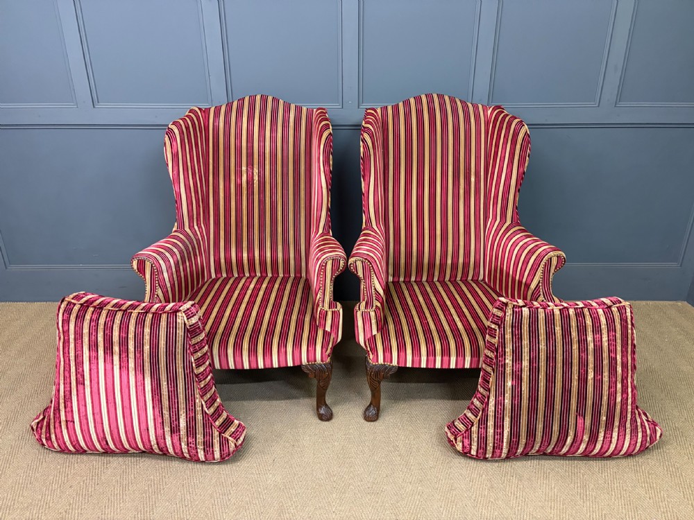 A pair of high-backed wing armchairs upholstered in red and gold striped velvet fabric with carved timber cabriole legs. View XVI