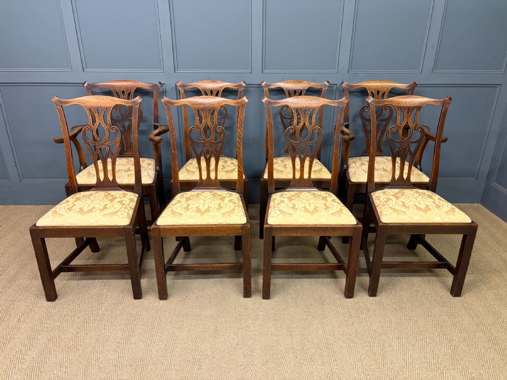 A set of eight brown oak Chippendale dining chairs including two armchairs and six side chairs with patterned fabric drop-in seats. View III