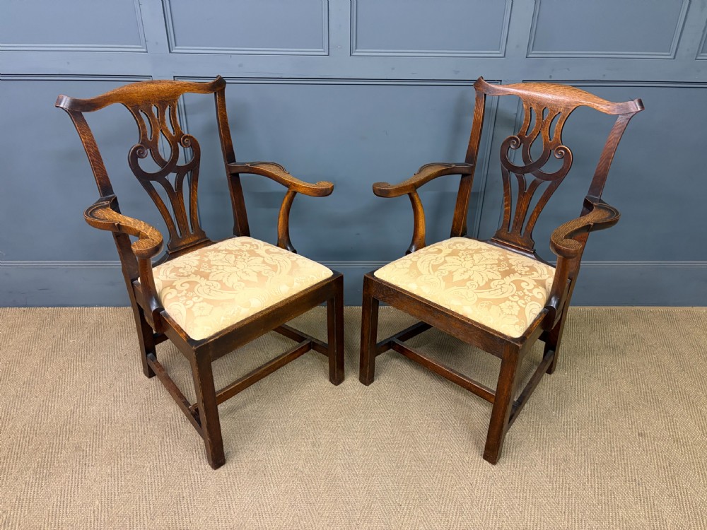 A set of eight brown oak Chippendale dining chairs including two armchairs and six side chairs with patterned fabric drop-in seats. View XIII