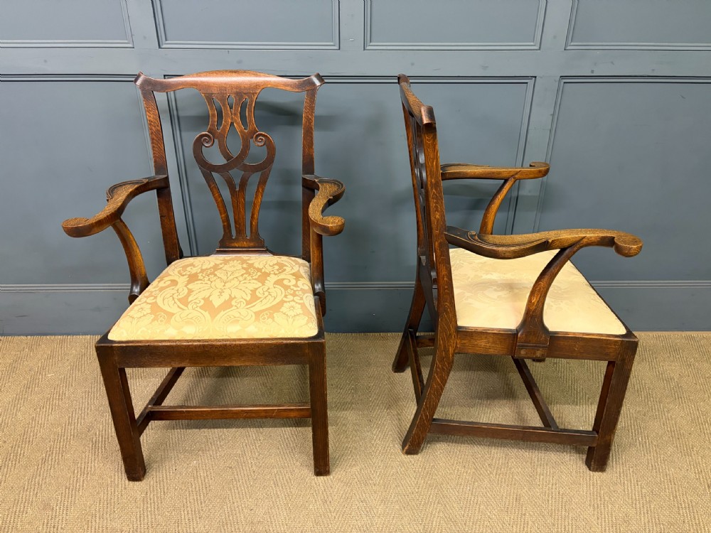 A set of eight brown oak Chippendale dining chairs including two armchairs and six side chairs with patterned fabric drop-in seats. View XIV