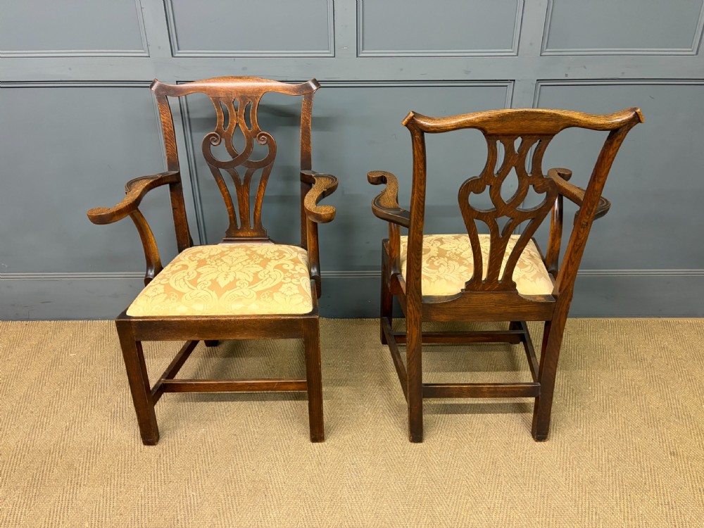 A set of eight brown oak Chippendale dining chairs including two armchairs and six side chairs with patterned fabric drop-in seats. View XV