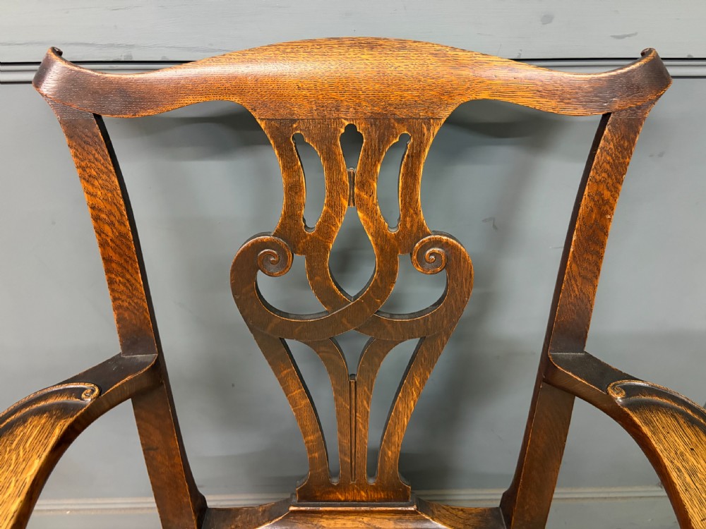 A set of eight brown oak Chippendale dining chairs including two armchairs and six side chairs with patterned fabric drop-in seats. View XVIII