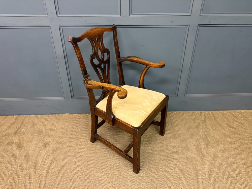A set of eight brown oak Chippendale dining chairs including two armchairs and six side chairs with patterned fabric drop-in seats. View XIX