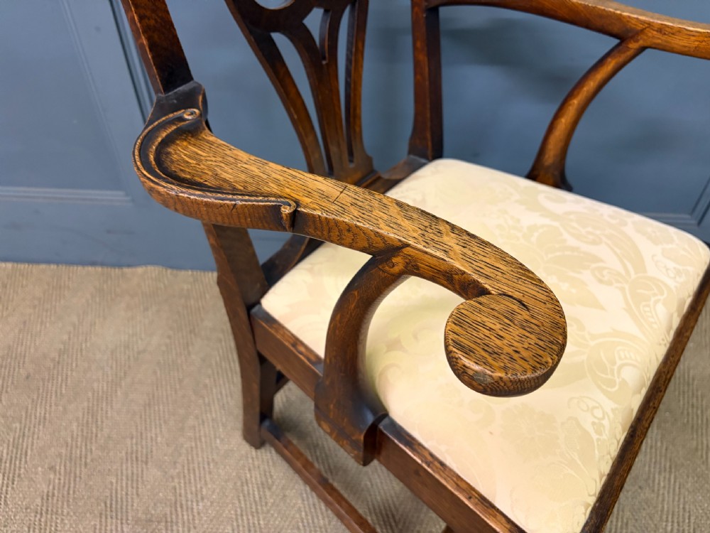 A set of eight brown oak Chippendale dining chairs including two armchairs and six side chairs with patterned fabric drop-in seats. View XX