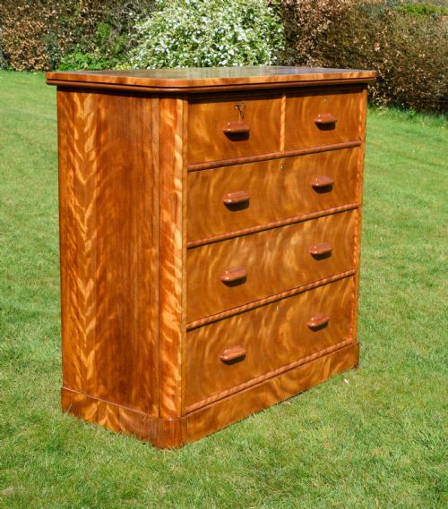 fig 1. Victorian golden birch chest of drawers featuring a two-over-three drawer configuration, rounded corners, integrated timber handles, and a plinth base.